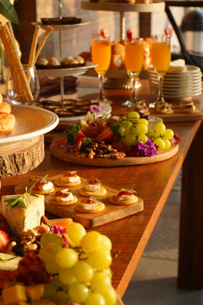 A beautifully arranged buffet table with various appetizers and drinks in a warm setting.